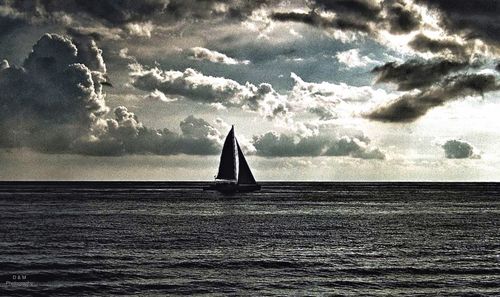 Scenic view of sea against cloudy sky