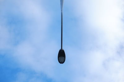 Low angle view of street light against cloudy sky on sunny day