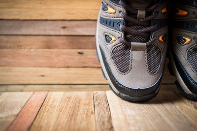 Close-up of hiking boots on wooden table