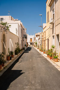 Street amidst buildings against sky