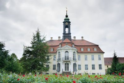 Low angle view of building against cloudy sky