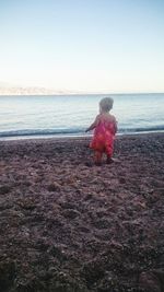 Full length of girl standing at beach