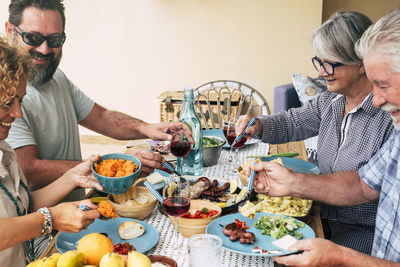 Midsection of woman holding food while sitting on table