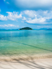 Scenic peaceful white sand beach, clear turquoise sea with koh kham view. koh mak island, thailand.