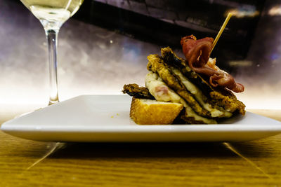 Close-up of serving food in plate on table