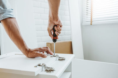 Midsection of man working on table