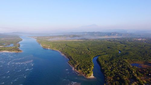 Aerial view of land and sea against sky