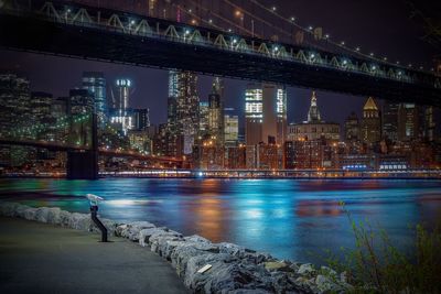 Manhattan bridge over east river in city at night