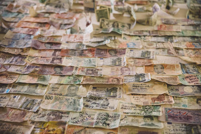 Full frame shot of paper currencies arranged on table