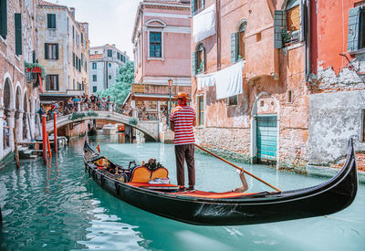 Boat in canal along buildings