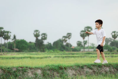 Full length of boy on field