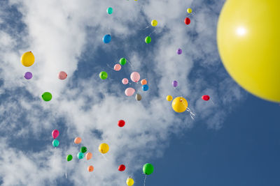 Low angle view of balloons against sky