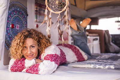 Portrait of smiling mature woman relaxing in caravan