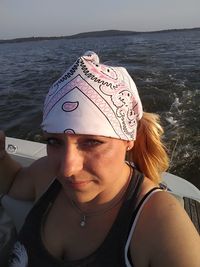 Portrait of woman traveling in boat on sea