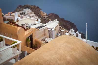 High angle view of buildings by sea against sky