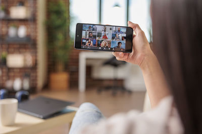 Midsection of woman using mobile phone