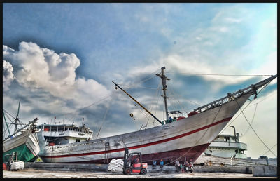 Harbor against cloudy sky