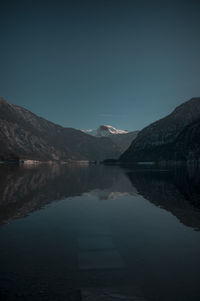 Scenic view of lake and mountains against clear sky