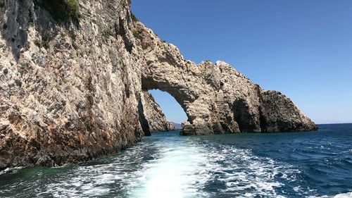 Scenic view of sea against clear blue sky
