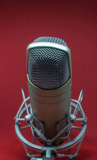 Close-up of microphone against red background