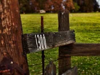 Close-up of wooden fence on field