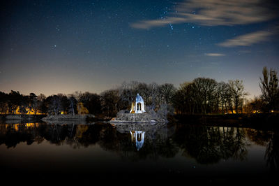 Scenic view of lake against sky at night