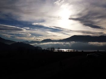 Silhouette landscape against calm sea