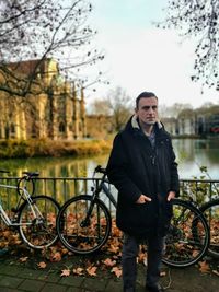 Portrait of man standing against lake