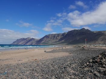 Scenic view of mountains against cloudy sky