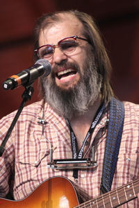 Portrait of mature man playing guitar