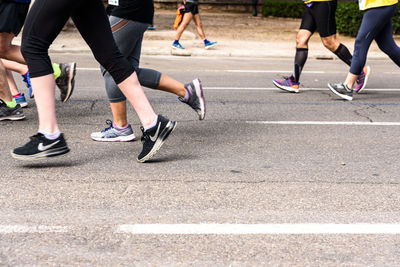 Low section of people running on road