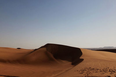 Scenic view of desert against clear sky