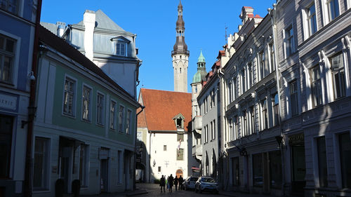 Street amidst buildings against sky in city