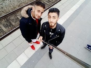 High angle portrait of young couple sitting on bus