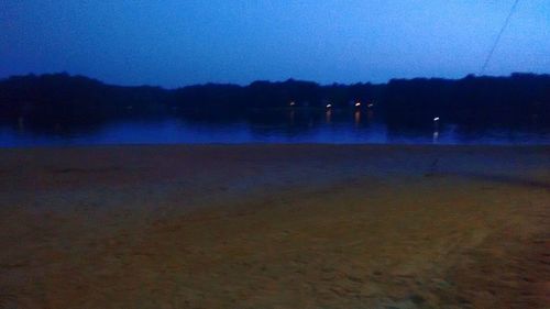 Scenic view of lake against sky at night