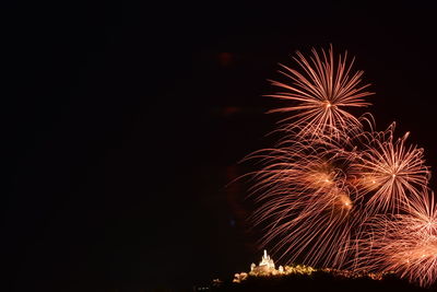 Low angle view of firework display at night