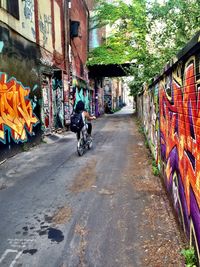 Woman walking on road in city