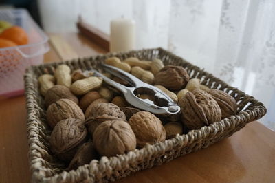 Close-up of food in plate on table walnut nut orange candle basket