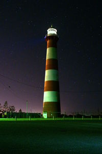 Low angle view of lighthouse against sky at night