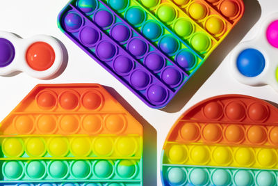 High angle view of multi colored pencils on white background