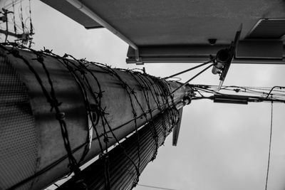 Low angle view of barbed wire against sky