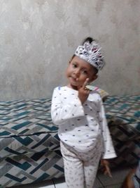 Girl looking away while standing at home