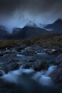 Scenic view of waterfall against sky