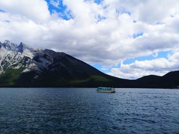 Scenic view of sea and mountains against sky