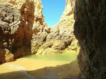 Scenic view of rock formations against blue sky