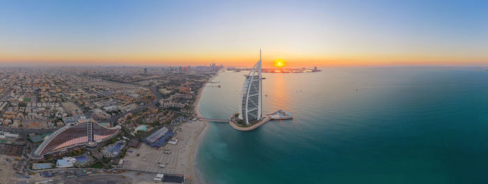 High angle view of buildings in city during sunset