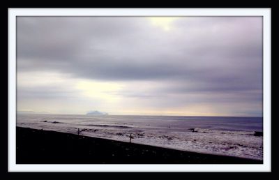 Scenic view of sea against cloudy sky