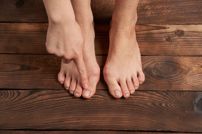 Low section of people on wooden floor