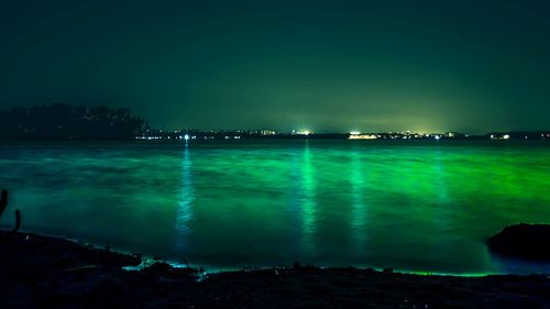 Scenic view of sea against clear sky at night