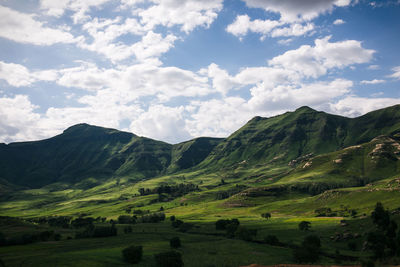 Scenic view of green mountains against sky